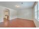 A bright living room with hardwood floors and neutral walls leading into the kitchen area at 1064 Lexi Ct, Ladson, SC 29456