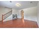 Open living room with stairs, hardwood floors, and view into other rooms at 1064 Lexi Ct, Ladson, SC 29456