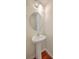 Compact powder room featuring a pedestal sink with a round mirror and sleek lighting at 1064 Lexi Ct, Ladson, SC 29456