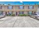Well-maintained townhouse exterior with red shutters, landscaping, and private parking at 1064 Lexi Ct, Ladson, SC 29456