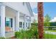 Charming exterior view showcasing white pillars, Azalea Ridge signage, lush greenery and seating at 111 Orchard Blossom Ct, Summerville, SC 29485