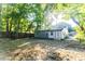 The backyard features a mix of mature trees, sunlight, and fencing at 1129 Dickson Ave, Hanahan, SC 29410