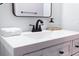 Close-up of a bathroom vanity with a white countertop, black faucet, and a modern mirror at 1129 Dickson Ave, Hanahan, SC 29410