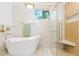 Bathroom features an elegant tub, glass shower, and gold fixtures at 1129 Dickson Ave, Hanahan, SC 29410