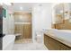 Bright bathroom featuring a glass shower, soaking tub, and double sink vanity at 1129 Dickson Ave, Hanahan, SC 29410