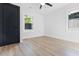 Bright bedroom with light floors, two windows, and a black door, offering a cozy and inviting atmosphere at 1129 Dickson Ave, Hanahan, SC 29410