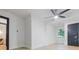 Light and open bedroom with a ceiling fan, light floors, a dark door, and large windows at 1129 Dickson Ave, Hanahan, SC 29410