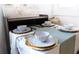 Dining room table set with elegant dinnerware and decorative accents at 1129 Dickson Ave, Hanahan, SC 29410