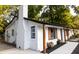 Angled exterior shot showcasing new white brick paint, a dark roof and updated wooden shutters at 1129 Dickson Ave, Hanahan, SC 29410