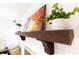 A fireplace mantel featuring colorful painting and lush green plant at 1129 Dickson Ave, Hanahan, SC 29410