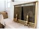 Detailed view of a fireplace screen and mantel decorations in a cozy setting at 1129 Dickson Ave, Hanahan, SC 29410