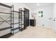 Well-lit laundry room with custom shelving, storage, and a tiled floor at 1129 Dickson Ave, Hanahan, SC 29410