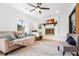 Bright living room with a fireplace, comfortable sofa, ceiling fan, and natural light at 1129 Dickson Ave, Hanahan, SC 29410