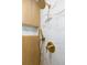 Close up of shower head with marble tiling and wood accent at 1129 Dickson Ave, Hanahan, SC 29410