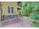 A covered patio and backyard surrounded by a green, wooded area and the side of a yellow house at 1184 Dingle Rd, Mount Pleasant, SC 29466