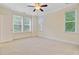 Bright bedroom with neutral carpet, ceiling fan, and abundant natural light through multiple windows at 1184 Dingle Rd, Mount Pleasant, SC 29466
