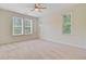 Bright bedroom with neutral walls, plush carpet, a ceiling fan, and three large windows at 1184 Dingle Rd, Mount Pleasant, SC 29466