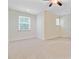 Bright bedroom with neutral carpet, a ceiling fan, and natural light from the two large windows at 1184 Dingle Rd, Mount Pleasant, SC 29466
