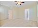 Bright carpeted bedroom features neutral walls, a ceiling fan, and multiple doorways with white trim at 1184 Dingle Rd, Mount Pleasant, SC 29466