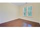 Comfortable bedroom with hardwood floors and a window overlooking a green landscape at 1184 Dingle Rd, Mount Pleasant, SC 29466