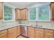 Kitchen with wood cabinets, granite countertops, stainless steel dishwasher and a double sink at 1184 Dingle Rd, Mount Pleasant, SC 29466