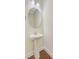 Stylish powder room featuring a pedestal sink, round mirror, and hardwood flooring at 1184 Dingle Rd, Mount Pleasant, SC 29466