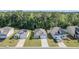 An aerial view of several modern single-Gathering homes with manicured lawns and tree-lined streets at 123 Lagoona Dr, Summerville, SC 29483