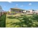 Large fenced-in backyard with healthy lawn and landscaped planting beds surrounding the home at 123 Lagoona Dr, Summerville, SC 29483