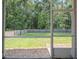 A screened-in porch provides a view of a lush green backyard at 123 Lagoona Dr, Summerville, SC 29483