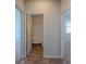 Hallway view to bathroom with tub/shower combo, neutral paint, and well-lit space at 123 Lagoona Dr, Summerville, SC 29483