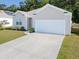 Charming single-story home boasts a two-car garage and a well-maintained front lawn and landscaping at 123 Lagoona Dr, Summerville, SC 29483