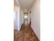 Long hallway showcases durable wood-look flooring, leading to bedrooms and living spaces at 123 Lagoona Dr, Summerville, SC 29483