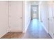 Long hallway showcases durable wood-look flooring, leading to the front door at 123 Lagoona Dr, Summerville, SC 29483