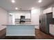Bright kitchen featuring white cabinets, stainless steel appliances, granite countertops, and a center island at 123 Lagoona Dr, Summerville, SC 29483