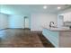 Open living space featuring hardwood floors, granite countertops, an island, and bright, neutral paint at 123 Lagoona Dr, Summerville, SC 29483