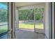 Relaxing screened-in patio with a view of the lush, green backyard at 123 Lagoona Dr, Summerville, SC 29483