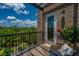 Relaxing balcony with views of lush trees and blue sky from the red brick building at 125 Pier View St # 408, Charleston, SC 29492