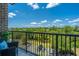 Scenic view from the balcony, showcasing lush greenery, blue sky, and a parking lot at 125 Pier View St # 408, Charleston, SC 29492