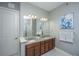 Elegant bathroom with double sinks, granite countertop, decorative art, and soft lighting for a spa-like experience at 125 Pier View St # 408, Charleston, SC 29492