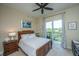 Inviting bedroom featuring wooden furniture, a ceiling fan, and balcony access at 125 Pier View St # 408, Charleston, SC 29492