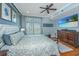 Inviting bedroom features a large bed, stylish furnishings, hardwood floors, and a large-screen television at 125 Pier View St # 408, Charleston, SC 29492
