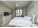 Bright bedroom with a large white dresser, comfortable bed, ceiling fan, and natural light for a cozy feel at 125 Pier View St # 408, Charleston, SC 29492