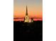 Beautiful view of an illuminated church at dusk, creating a serene and striking nighttime scene at 125 Pier View St # 408, Charleston, SC 29492