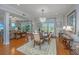 Bright dining room with chandelier, shuttered windows and hardwood floors open to living area at 125 Pier View St # 408, Charleston, SC 29492
