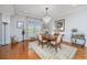 Dining room featuring chandelier, hardwood floors, and shuttered windows with elegant decor at 125 Pier View St # 408, Charleston, SC 29492