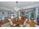 Dining room with chandelier, hardwood floors, and access to the kitchen and living area at 125 Pier View St # 408, Charleston, SC 29492
