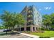 Modern condominium building with brick and concrete exterior and parking garage access at 125 Pier View St # 408, Charleston, SC 29492