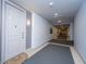 Well-lit hallway with neutral walls, carpet, and visible apartment doors at 125 Pier View St # 408, Charleston, SC 29492