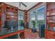 Well-appointed home office with custom shelving, hardwood floors, and large windows with exterior views at 125 Pier View St # 408, Charleston, SC 29492