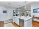 Bright kitchen featuring white cabinets, marble countertops and stainless steel appliances open to living area at 125 Pier View St # 408, Charleston, SC 29492